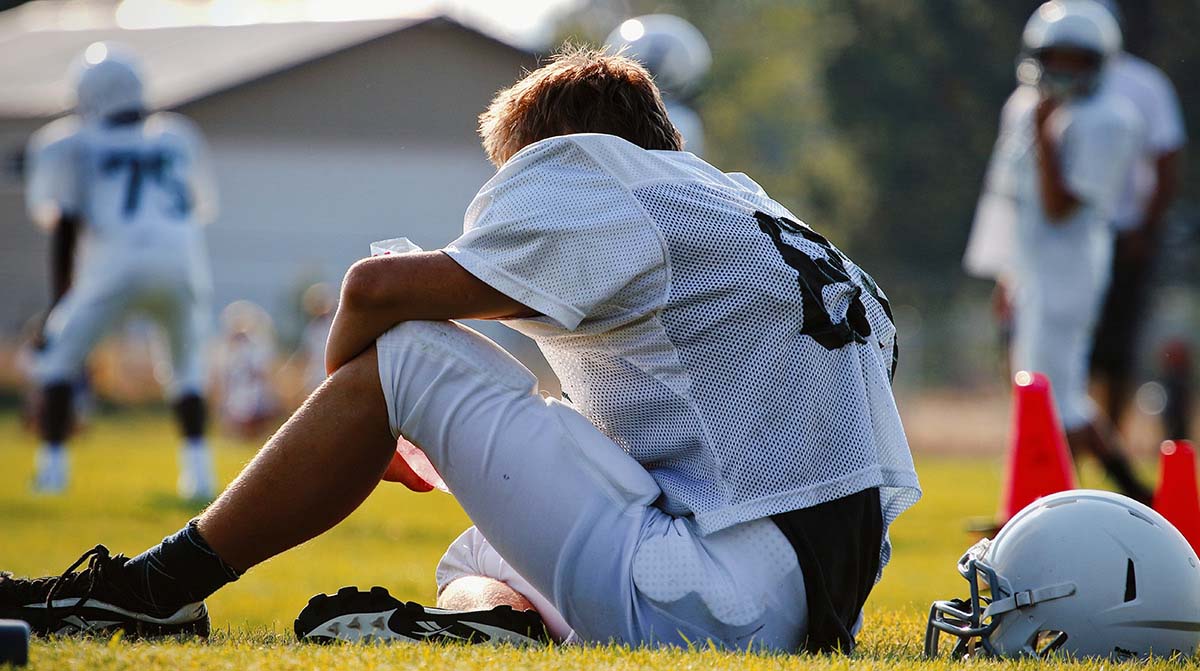 A football player sitting on the field
